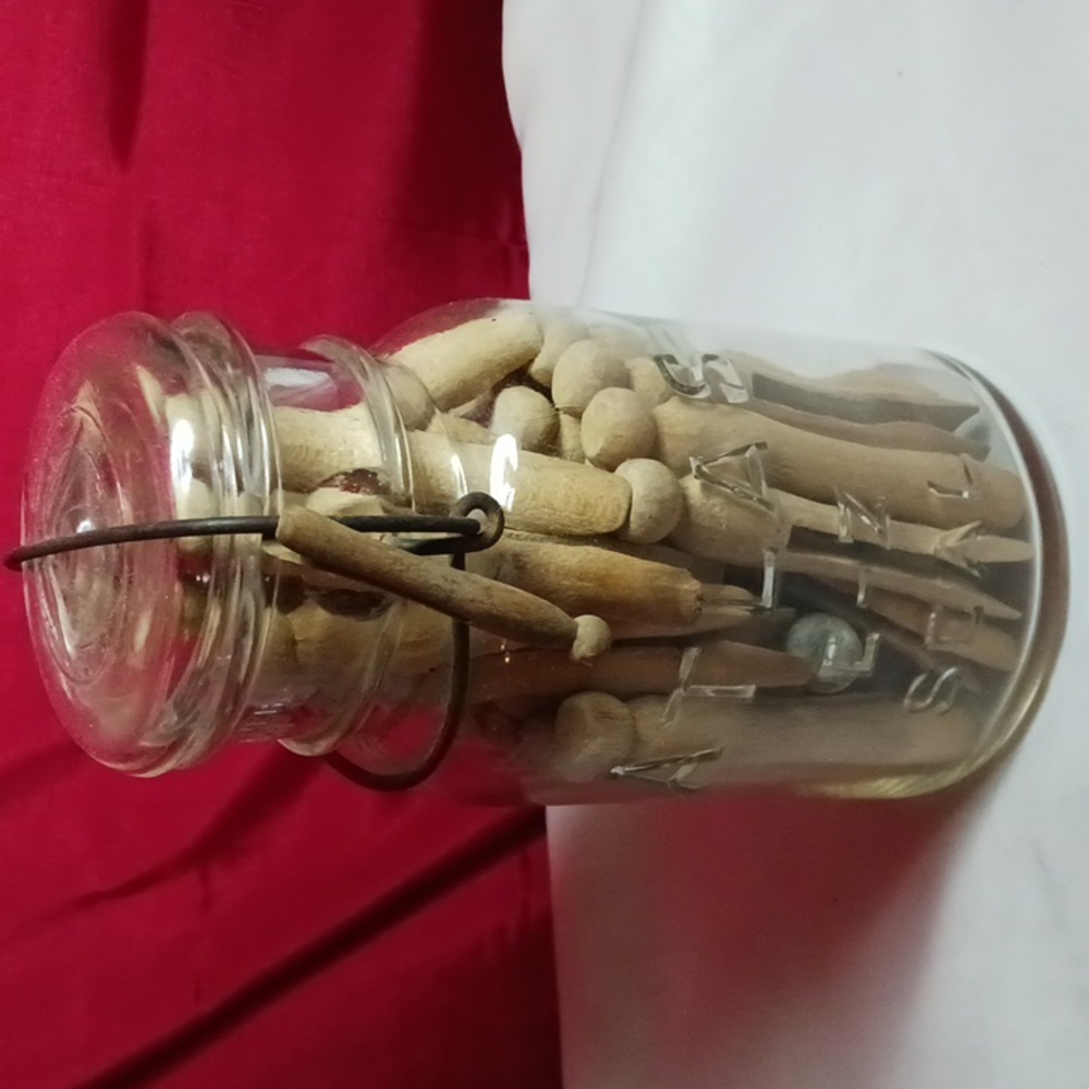 Antique atlas jar filled with antique clothes pins